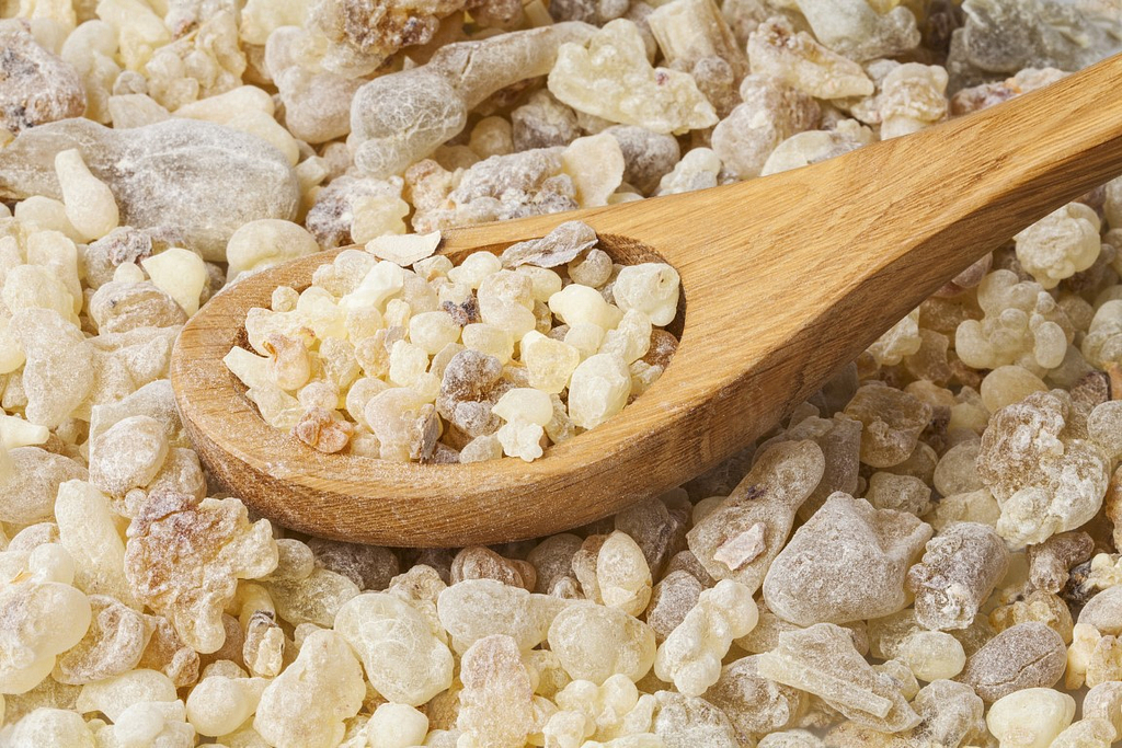 Frankincense background. Frankincense (Boswellia sacra) is an aromatic resin, used for religious rites, incense and perfumes