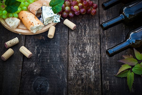 Wine bottles with grape leaves on wooden background with copy space selective focus ** Note: Soft Focus at 100%, best at smaller sizes