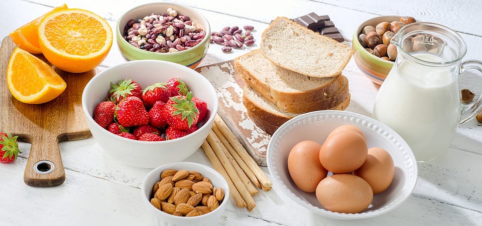 Allergy food concept. Allergic food on a white wooden background